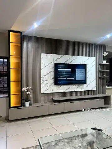 Custom modern entertainment wall unit with marble panel and LED display cabinet