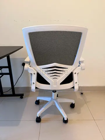 White ergonomic mesh office chair with caster wheels