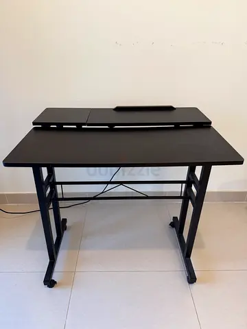 Compact black adjustable computer desk with wheels