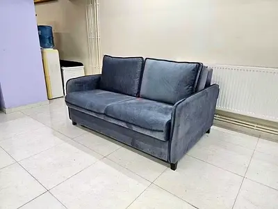 2-seater grey fabric sofa bed in good condition