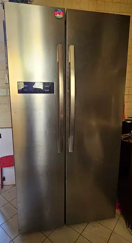 Large stainless steel side-by-side fridge-freezer in good working condition