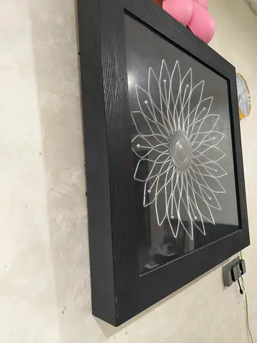 Black Framed Wall Art with Silver Sunburst Design