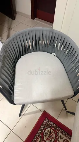 Grey woven rattan-style chair with cushion