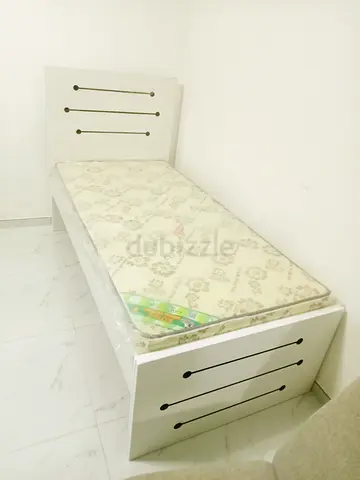 Single white wooden bed with mattress -