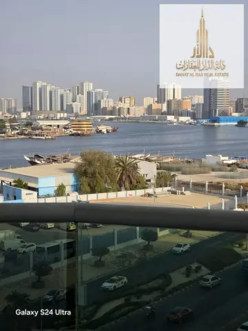 For rent: a one-bedroom apartment with a living room, balcony, and sea view with a private parking at Orient Towers, Ajman.
