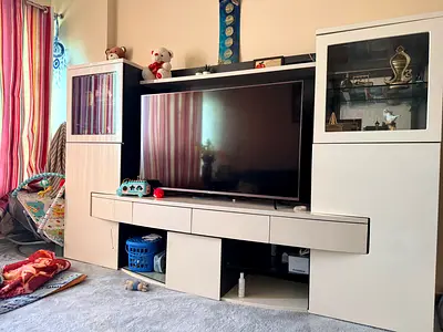 Modern white entertainment center with display cabinets and TV stand
