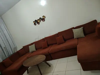 Large brown L-shaped sectional sofa with chaise