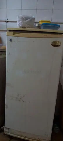 Used single-door mini fridge - functional, needs cleaning