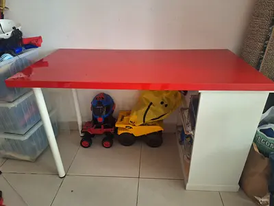 Kids study table with red top and storage - good condition. Detachable as well.