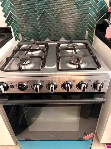 Used stainless steel 4-burner gas cooker with oven - good working condition