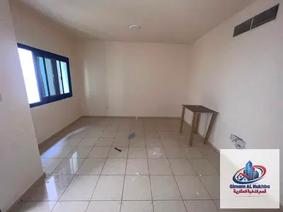Spacious studio in Al Majra with a balcony and stunning view, separate kitchen, central AC & gas, easy payments, free maintenance, and easy access to