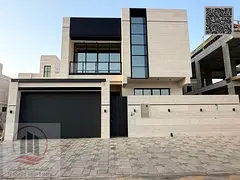 Villa for sale in Ajman, Al Bahia area. It features 5 master bedrooms, a majlis, 2 living rooms, and