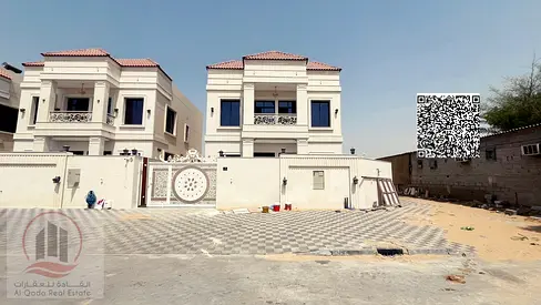 Corner villa for sale in Ajman, Al Helio area, including registration fees. 5 master bedrooms with a roof terrace, majlis, living room, and maid's roo