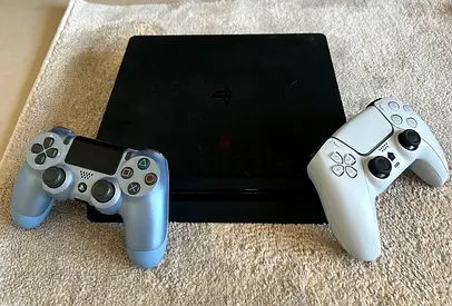 PlayStation 4 Slim with 2 DualShock Controllers and 9 games