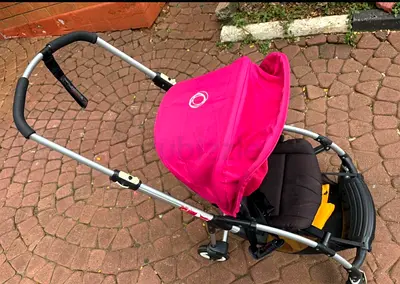 Lightly used pink Bugaboo-style stroller / pram - good condition