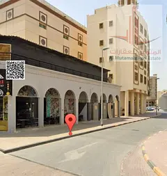 Commercial building for sale, second row from the Ajman Corniche**.