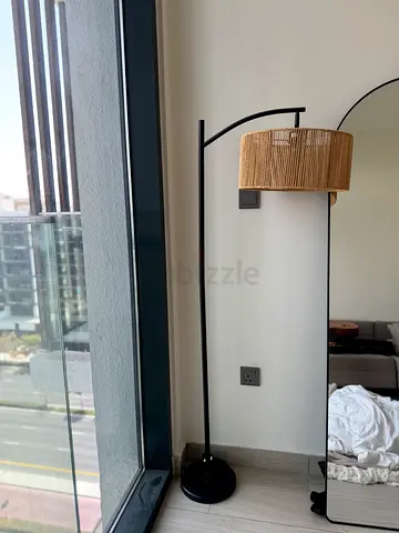 Modern arched floor lamp with woven rattan shade - good condition