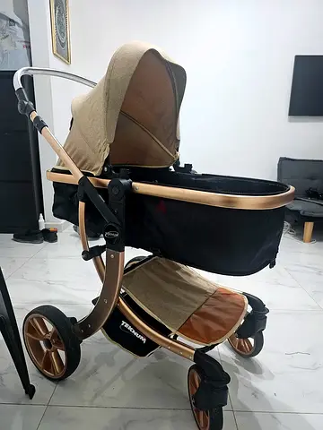 Gold frame pram-style baby stroller with bassinet - good condition
