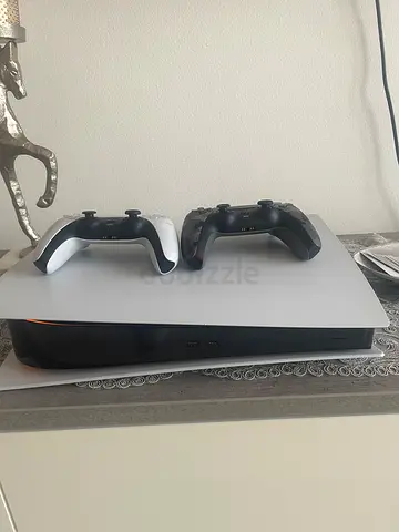 PlayStation 5 console with two DualSense controllers - good condition