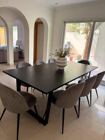 Modern black dining table with 8 upholstered chairs table size 220cm by 110cm from 2xl & JYSK