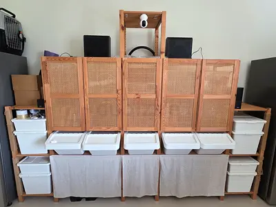 Custom wooden storage shelving unit with woven rattan doors and bins