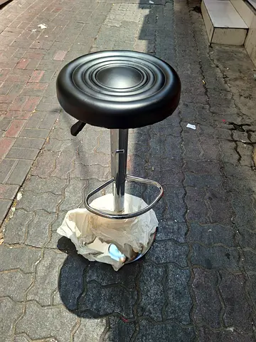 Black adjustable bar stool with footrest
