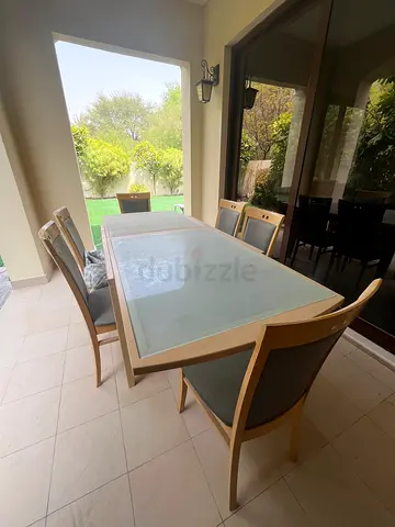 Outdoor wood and glass dining table