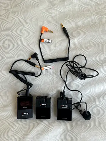 Three Comica wireless lavalier mic transmitters and receivers with lapel mics and cables