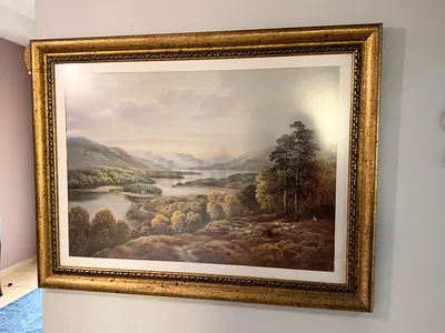 Framed landscape painting print in ornate gold frame