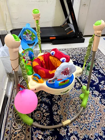 Baby jumper/exersaucer with toys - good working condition
