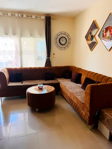 Brown L-shaped velvet corner sofa with ottoman - good condition