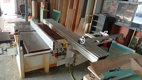 combination woodworking machine featuring an integrated sliding table panel saw, rip fence, and surf