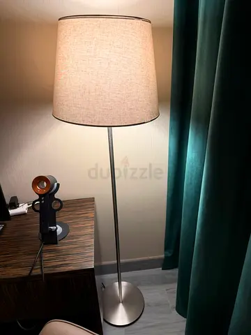Silver metal floor lamp with beige fabric shade