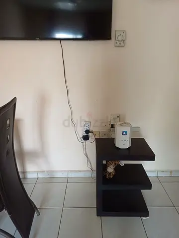 Small dark wood side table / TV stand with open shelves - good condition