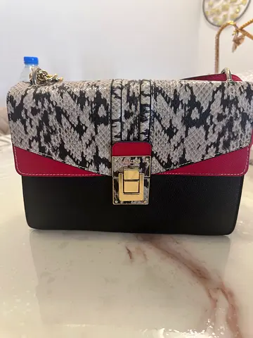 Black and snakeskin print crossbody bag with gold clasp