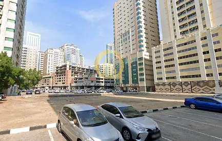 For sale: commercial and residential land in Al Nahda area, 10,000 sq ft on a 24-meter street, approved for ground + 5 parking + 15 floors