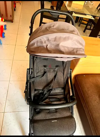 Lightly used grey baby stroller - compact and comfortable