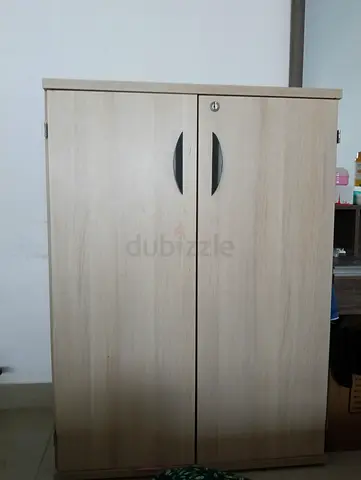 Light wood two-door storage cabinet with lock