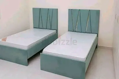 Pair of light teal single beds with headboards — set of 2