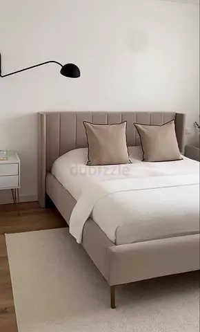Upholstered double bed with padded headboard