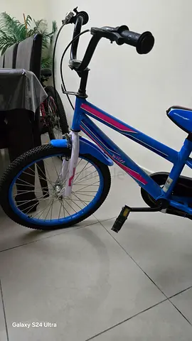 Blue kids bicycle with training wheels — good condition