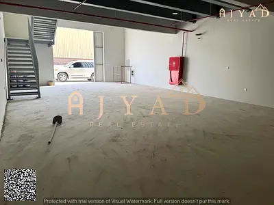 For annual rent: brand new commercial space first occupant in Ajman Industrial Area 1, near Beirut Street, with mezzanine and bathroom, area 2500 sqft
