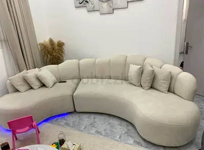 Light beige curved sectional sofa with cushions - modern design