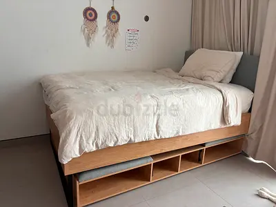 Twin wooden bed with built-in underbed trundle with two mattresses— excellent condition