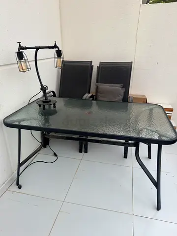 Outdoor glass-top dining table with metal frame (seats 4) - good condition