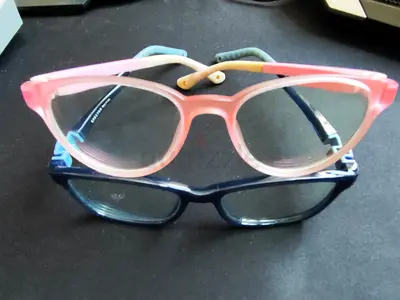 Two used eyeglass frames — pink cat-eye and navy rectangular (bundle)