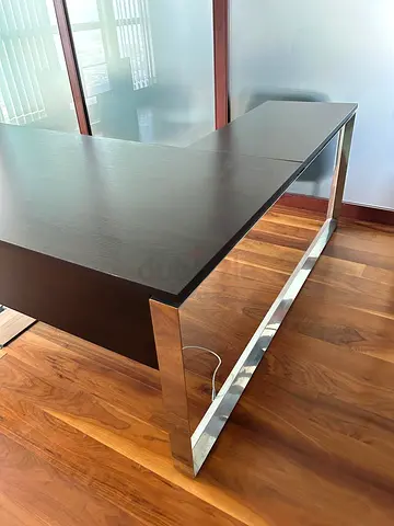 L-shaped modern executive office desk with chrome legs