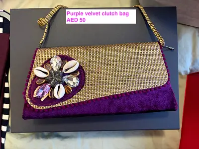 Purple velvet clutch bag with shell and crystal embellishments