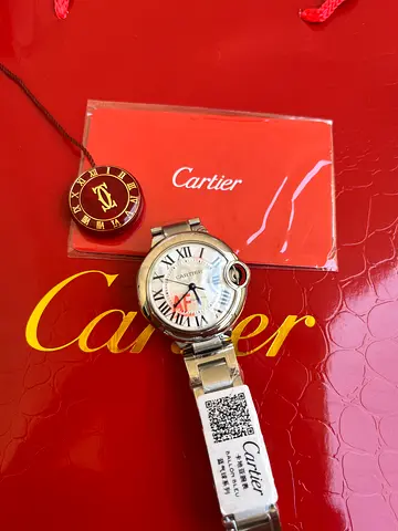 Cartier Ballon Bleu watch featuring a signature blue cabochon-set crown.