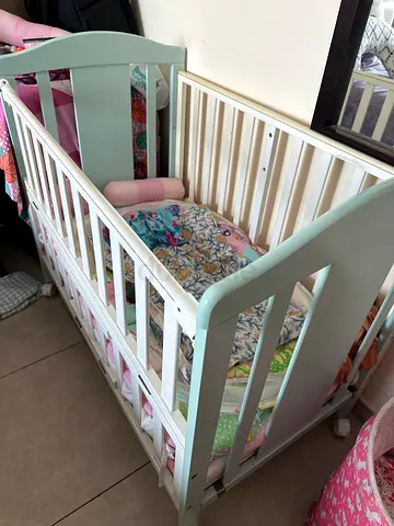 White wooden baby crib in good condition. Can be adjusted to 3 height as per the requirement